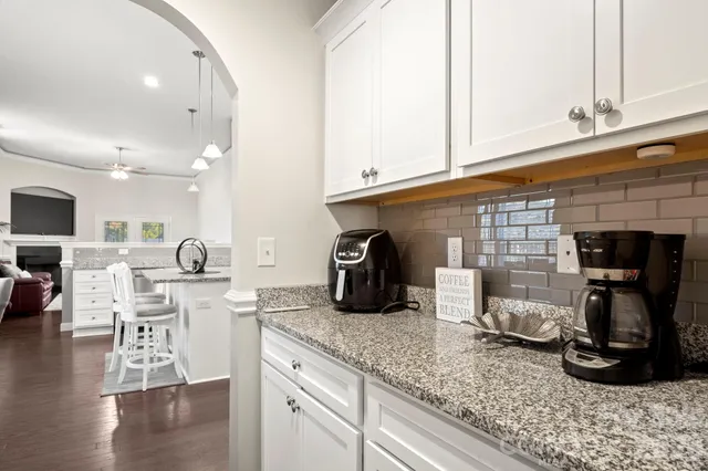 a kitchen with granite countertop a sink and a stove