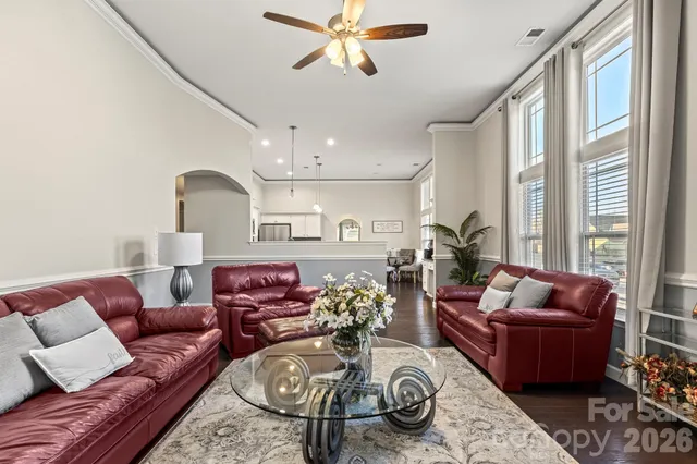 a living room with furniture ceiling fan and a rug
