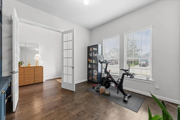 a view of a livingroom with workspace and a window