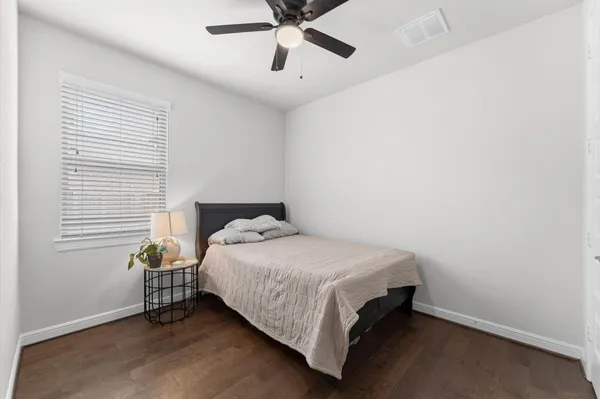 a bedroom with a bed and window