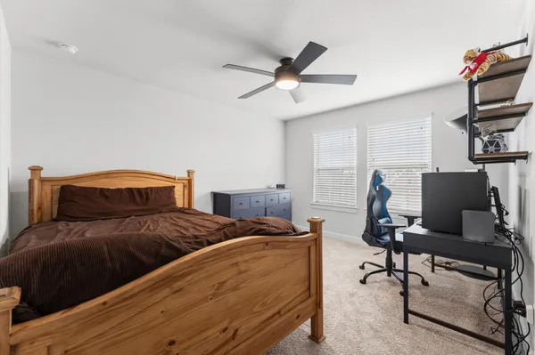 a bedroom with a bed and a desk