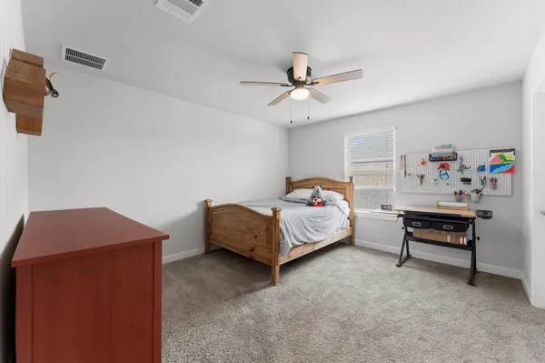 a bedroom with a bed and a table in it