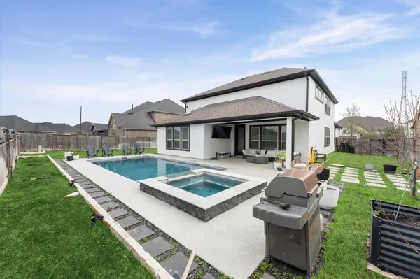 a view of a house with backyard and porch