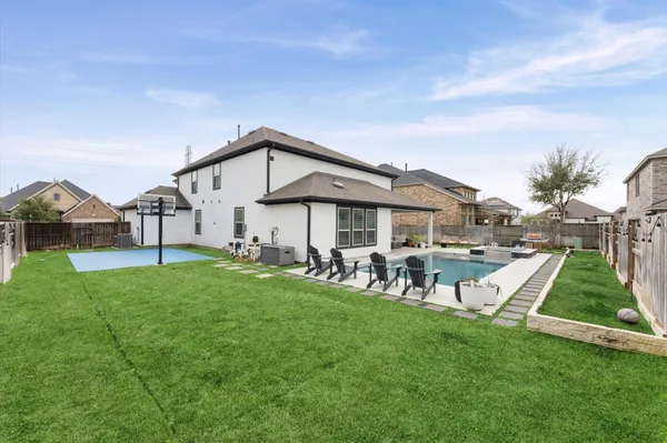 a view of a house with a yard and sitting area