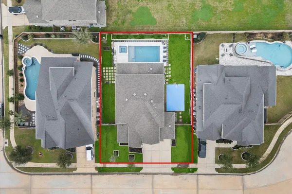 an aerial view of a house with outdoor space and a lake view