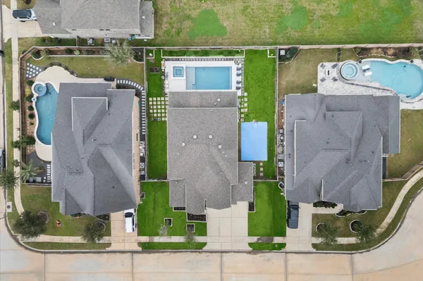 an aerial view of a house with outdoor space and parking