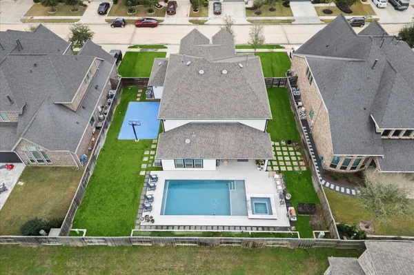 an aerial view of a house with a garden and swimming pool