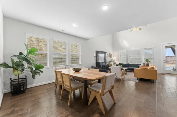 a view of a dining room with furniture and wooden floor