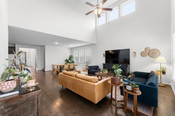 a living room with furniture a flat screen tv and a fireplace