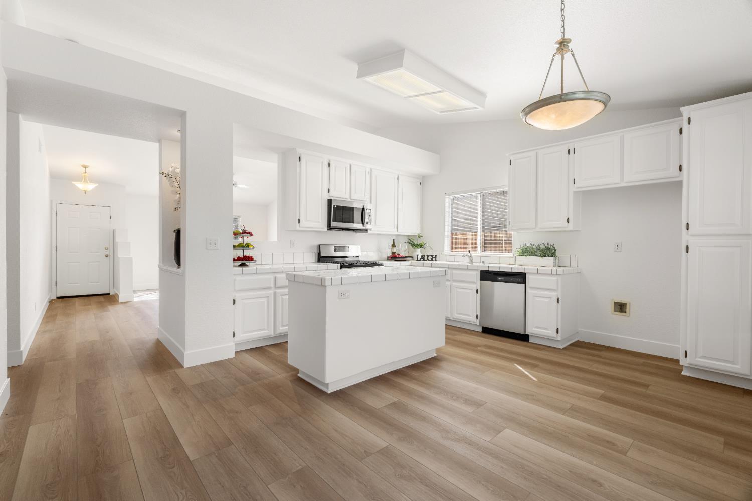 4730 Stuart Street Rocklin, CA 95765 - Photo 11 of 31 The kitchen and all main areas have brand new LVP flooring and the cabinets were just painted.