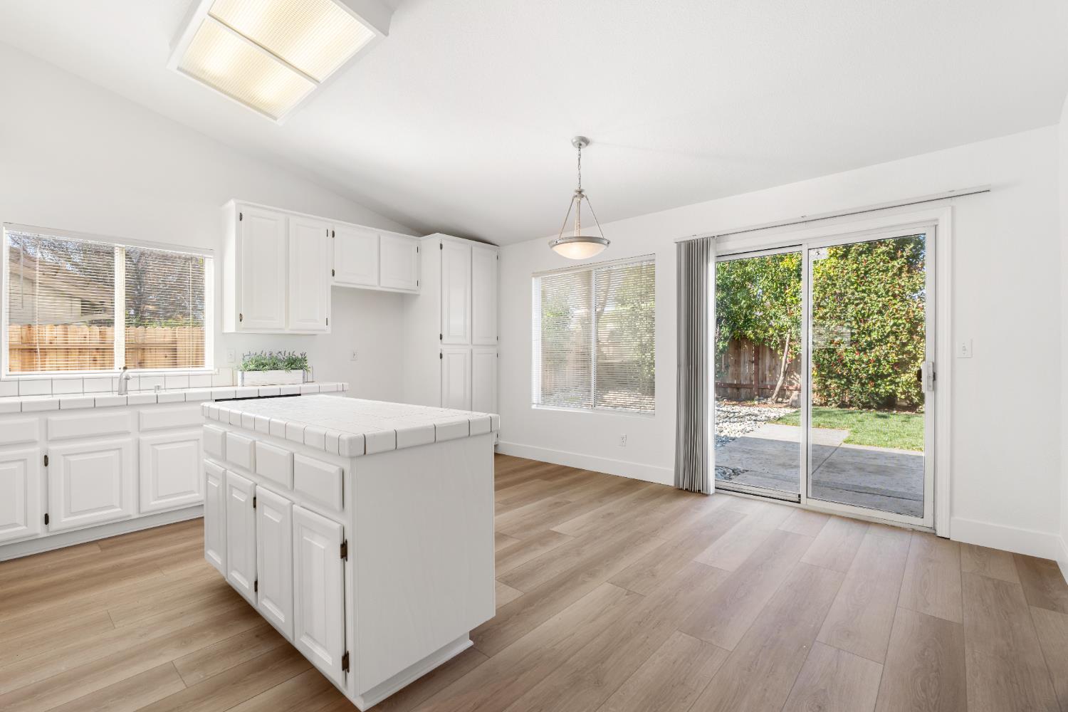 4730 Stuart Street Rocklin, CA 95765 - Photo 13 of 31 All new LVP flooring was installed throughout all the main areas. The slider opens to the newly updated backyard with new sod and updated sprinklers.