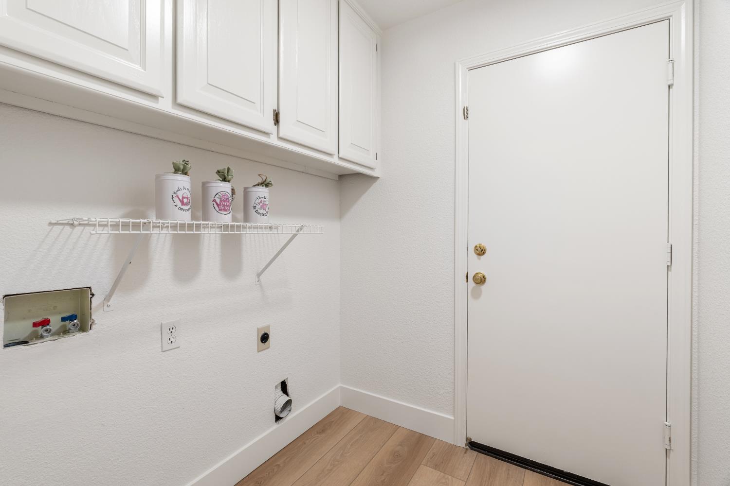4730 Stuart Street Rocklin, CA 95765 - Photo 26 of 31 The laundry offers additional storage with the cabinets that were just painted.