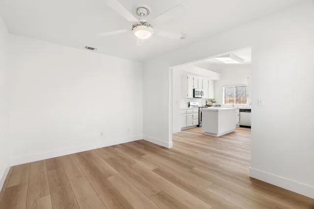 a view of a kitchen with a sink cabinets and wooden floor