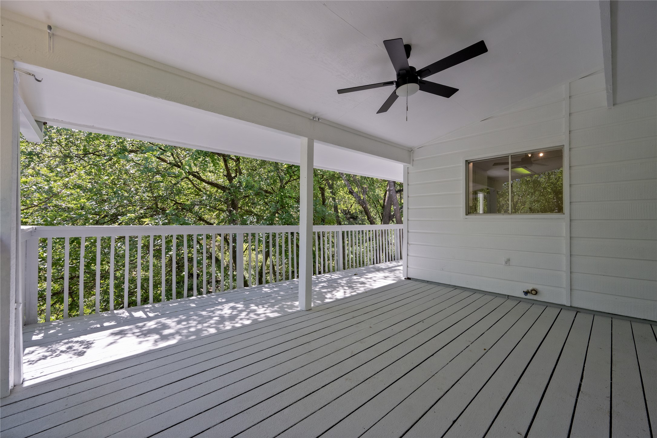 7 Hull Circle Austin, TX 78746 - Photo 16 of 17 An inviting covered deck offers serene treetop views, perfect for relaxing.