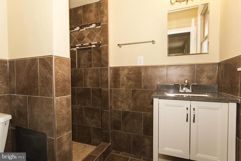 3405 Ripple Road Baltimore, MD 21244 - Photo 13 of 29 a bathroom with a sink a toilet and a mirror