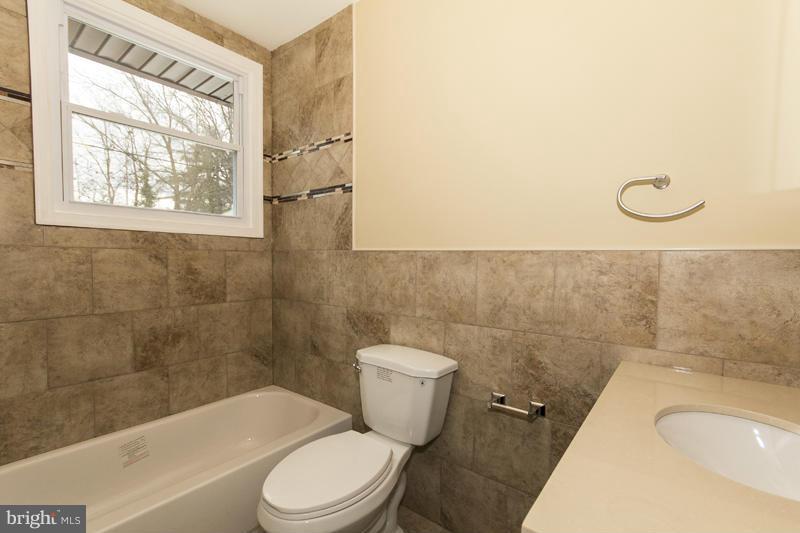 3405 Ripple Road Baltimore, MD 21244 - Photo 17 of 29 a bathroom with a toilet a sink and a bathtub