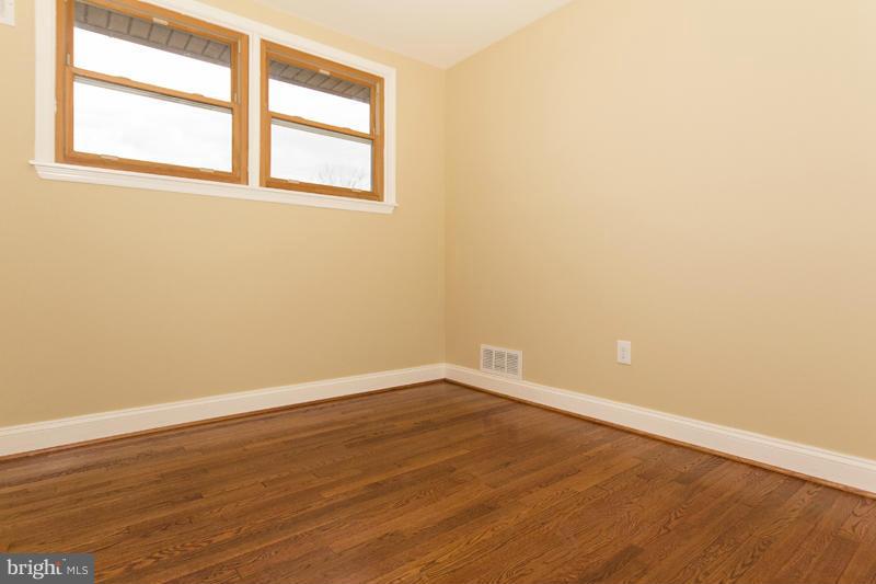 3405 Ripple Road Baltimore, MD 21244 - Photo 23 of 29 an empty room with wooden floor and windows