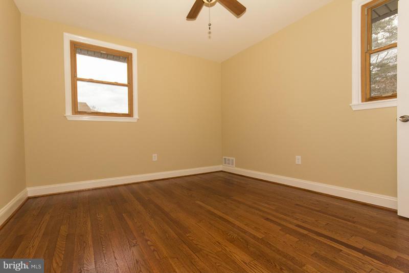 3405 Ripple Road Baltimore, MD 21244 - Photo 25 of 29 a view of an empty room with wooden floor and a window