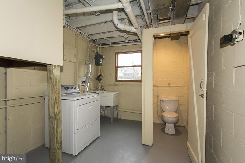 3405 Ripple Road Baltimore, MD 21244 - Photo 29 of 29 a bathroom with a granite countertop toilet sink and shower