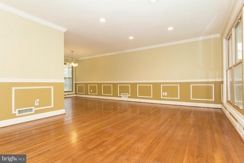 3405 Ripple Road Baltimore, MD 21244 - Photo 5 of 29 a view of an empty room with a window and wooden floor