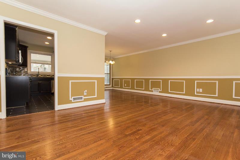 3405 Ripple Road Baltimore, MD 21244 - Photo 6 of 29 a view of an empty room with wooden floor and a kitchen