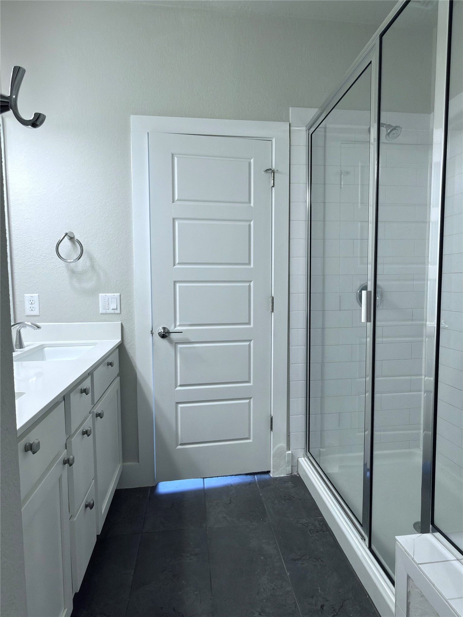 11216 Gadsen Lane Austin, TX 78754 - Photo 19 of 36 A well-appointed primary bathroom showcases a pristine vanity and a sleek glass-enclosed shower.