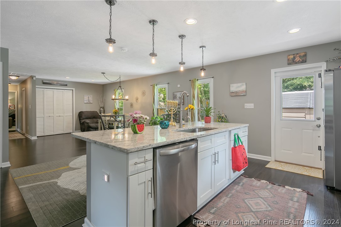 4730 Belford Road Fayetteville, NC 28314 - Photo 13 of 47 a kitchen with counter top space sink stove and refrigerator