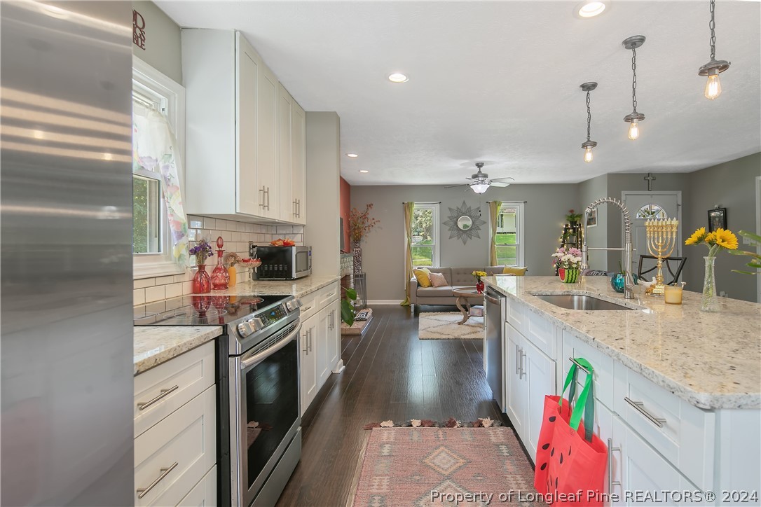 4730 Belford Road Fayetteville, NC 28314 - Photo 15 of 47 a kitchen with a sink stove and cabinets