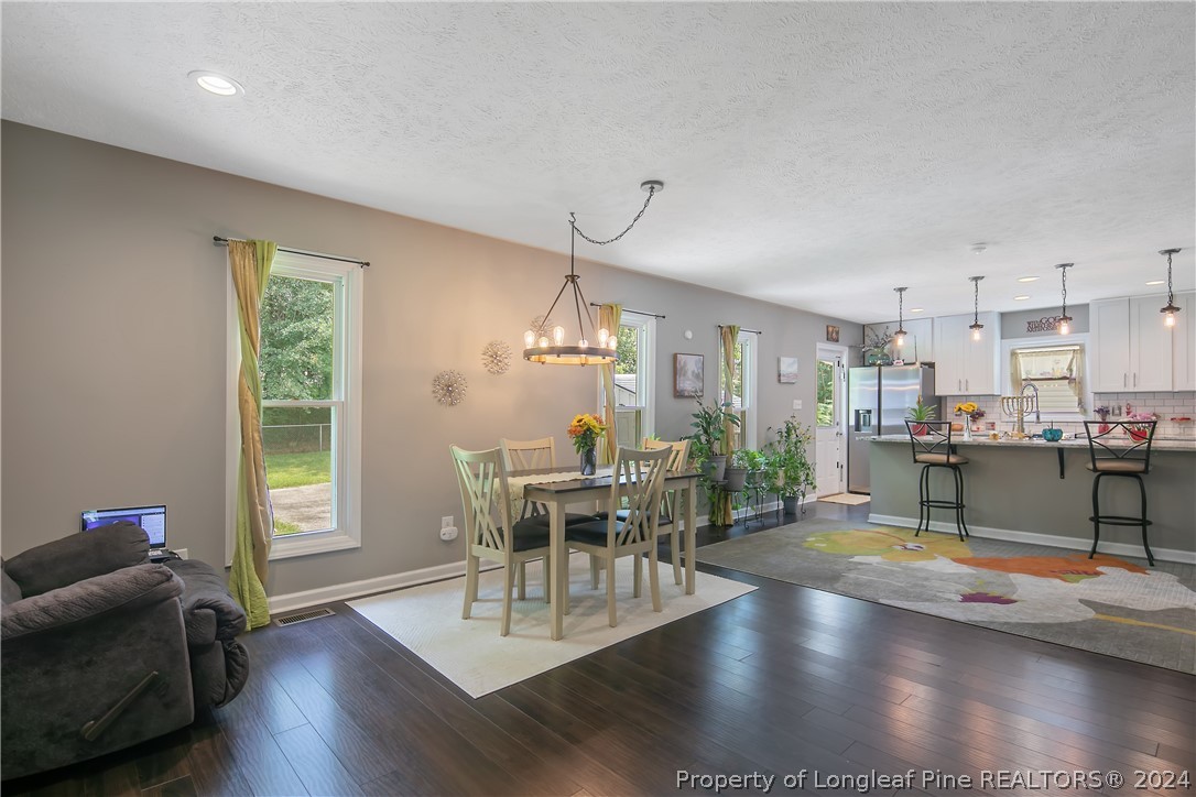 4730 Belford Road Fayetteville, NC 28314 - Photo 23 of 47 a view of a dining room with furniture and wooden floor