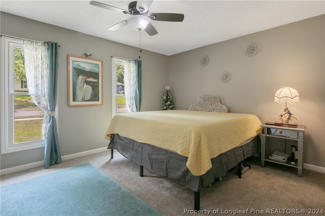 4730 Belford Road Fayetteville, NC 28314 - Photo 26 of 47 a bedroom with a bed and a chandelier