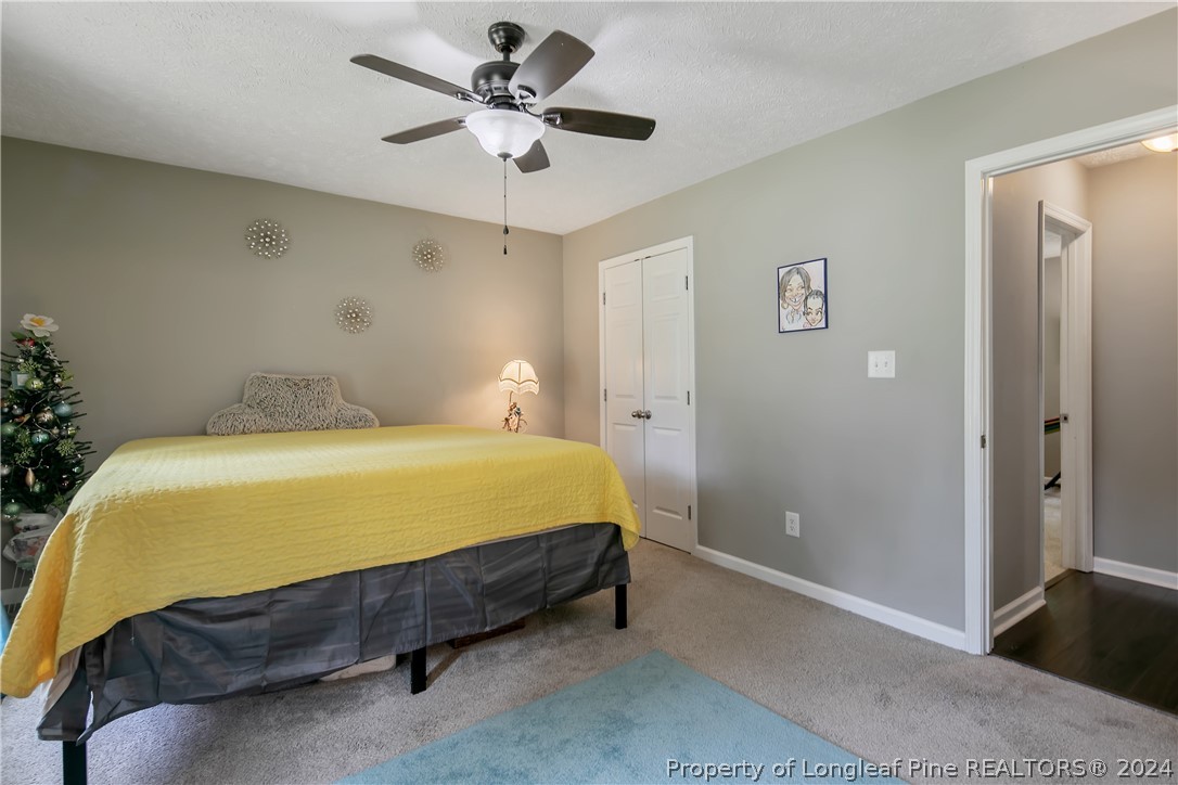 4730 Belford Road Fayetteville, NC 28314 - Photo 27 of 47 a bed sitting in a bedroom next to a bathroom
