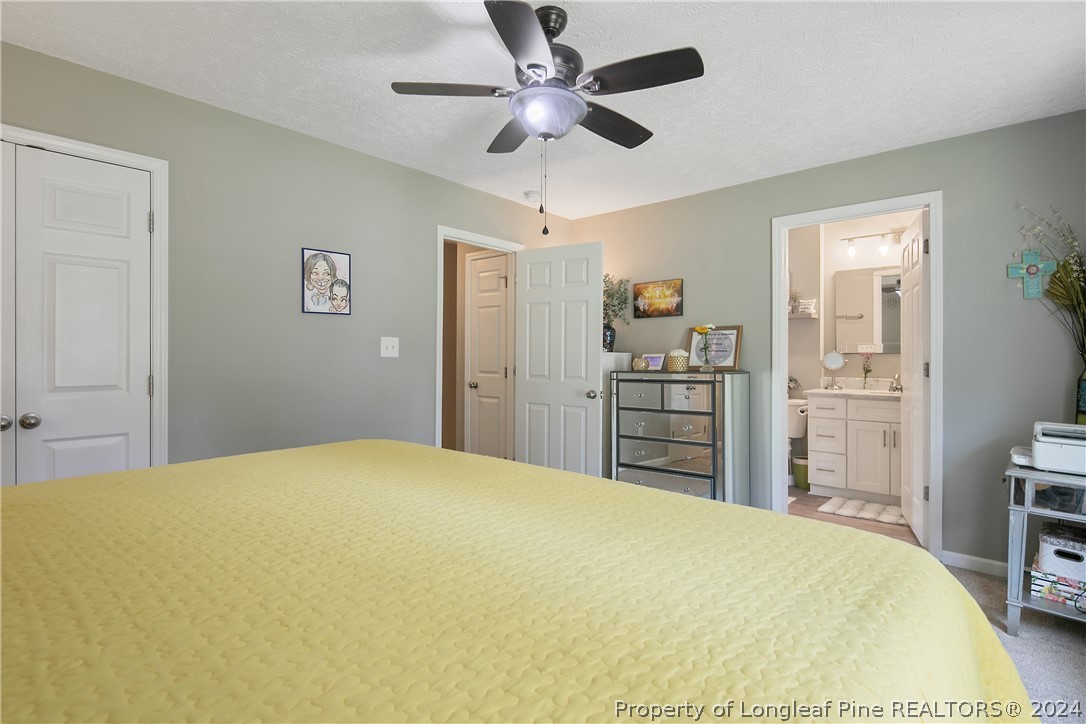 4730 Belford Road Fayetteville, NC 28314 - Photo 28 of 47 a bedroom with a bed and a chandelier