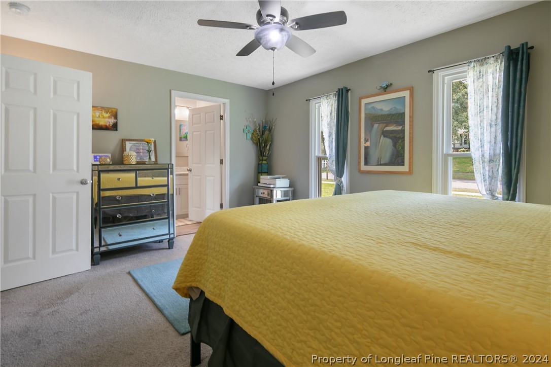 4730 Belford Road Fayetteville, NC 28314 - Photo 29 of 47 a bedroom with a bed and a chandelier
