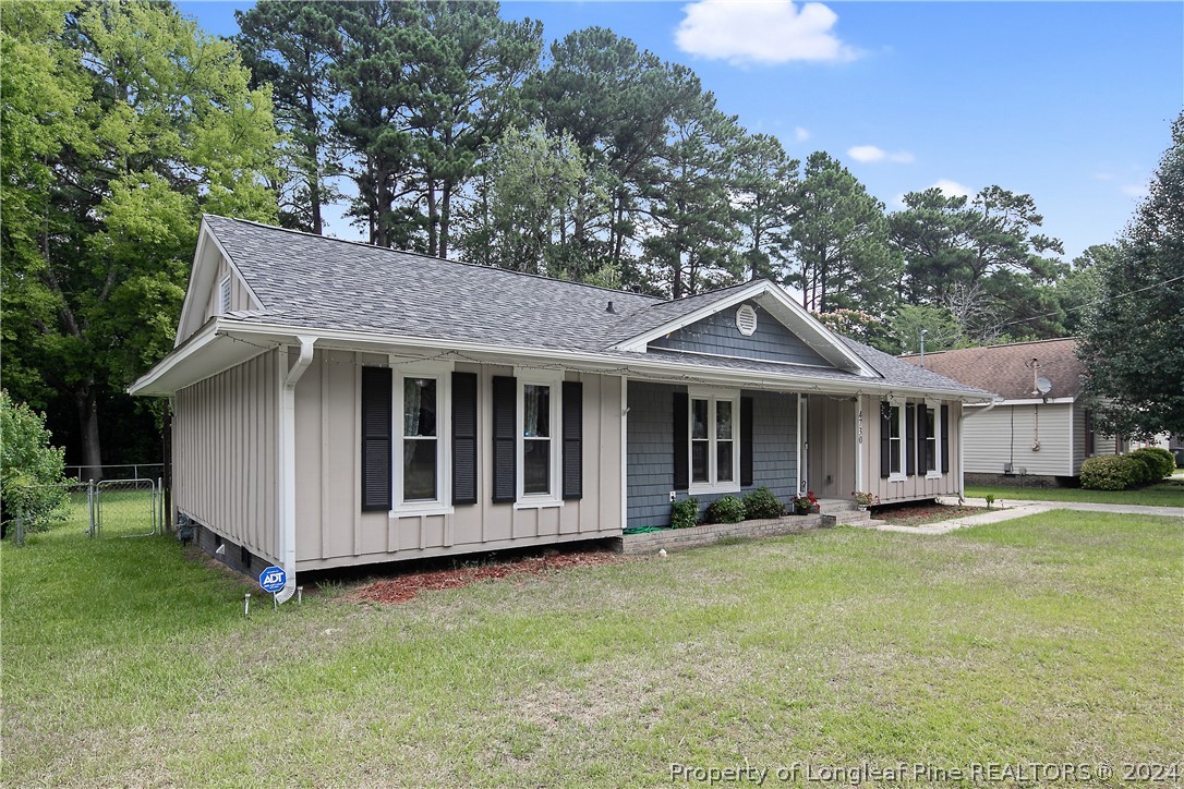 4730 Belford Road Fayetteville, NC 28314 - Photo 3 of 47 a view of a house with a yard and large trees