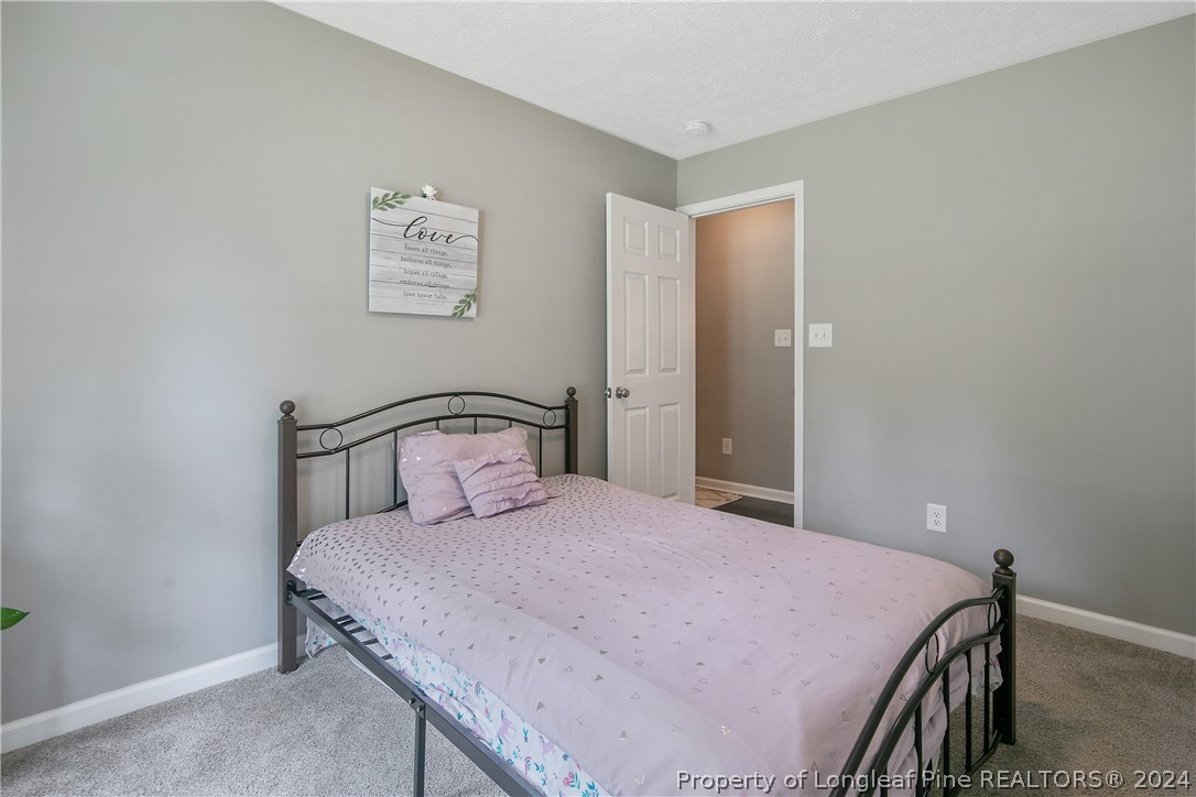 4730 Belford Road Fayetteville, NC 28314 - Photo 35 of 47 a bedroom with a bed and a table
