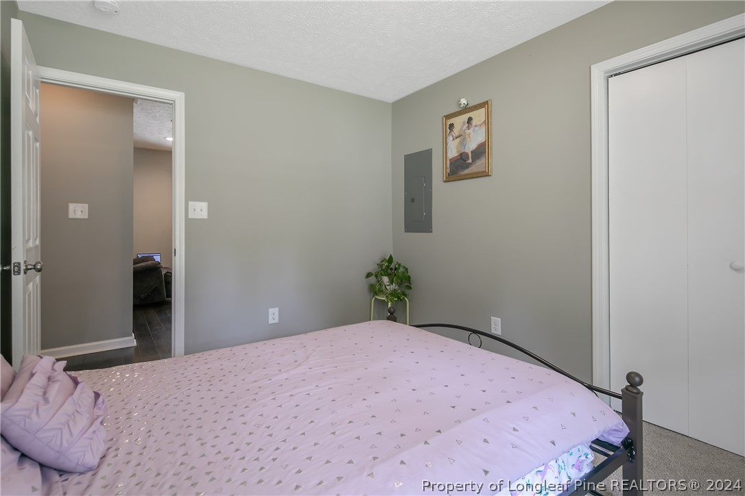 4730 Belford Road Fayetteville, NC 28314 - Photo 36 of 47 a bedroom with a bed and hallway