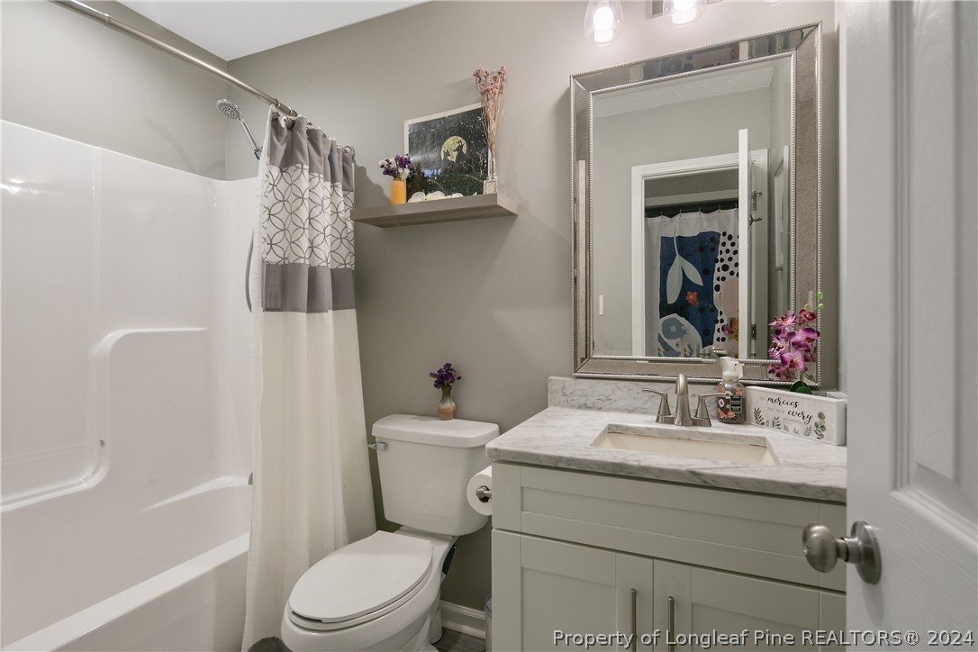 4730 Belford Road Fayetteville, NC 28314 - Photo 37 of 47 a bathroom with a sink toilet and shower