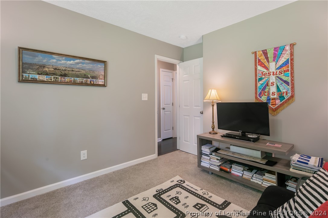 4730 Belford Road Fayetteville, NC 28314 - Photo 41 of 47 a living room with furniture and a flat screen tv
