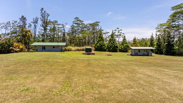a swimming pool with trees in the background