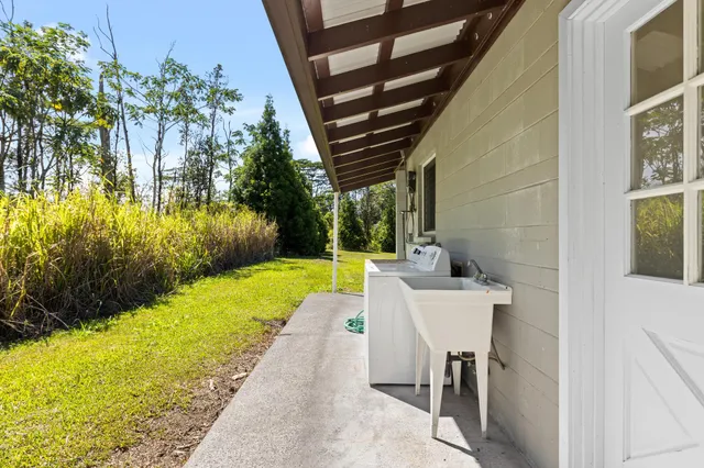 a view of a patio with table and chairs with wooden floor and fence