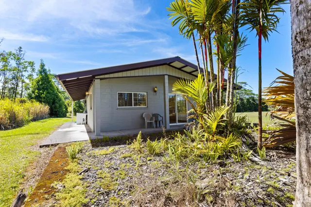 a house view with swimming pool in front