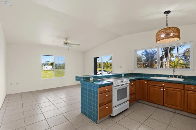 a kitchen with granite countertop a sink and a window