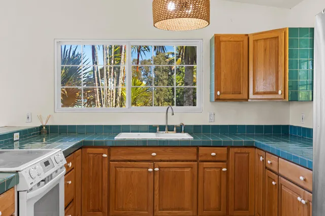 a kitchen with a sink and large window