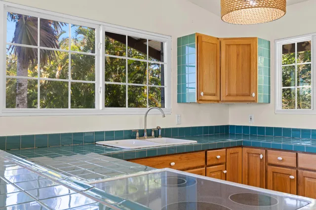 a kitchen with a stove and a chandelier