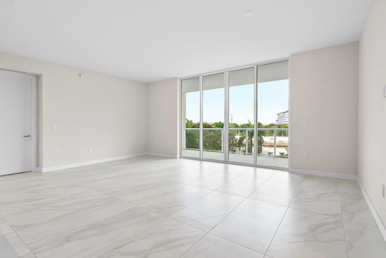 220 Southeast Mizner Boulevard, Unit 506 Boca Raton, FL 33432 - Photo 14 of 64 a view of an empty room with wooden floor and a floor to ceiling window
