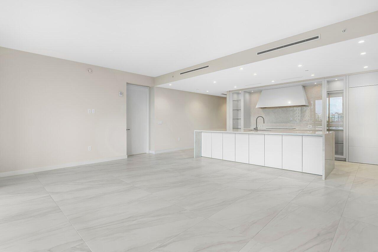 220 Southeast Mizner Boulevard, Unit 506 Boca Raton, FL 33432 - Photo 16 of 64 a view of a kitchen with a sink and a refrigerator
