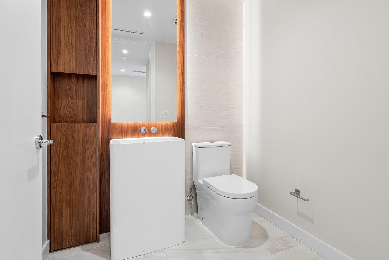 220 Southeast Mizner Boulevard, Unit 506 Boca Raton, FL 33432 - Photo 21 of 64 a white toilet sitting next to a bathroom sink