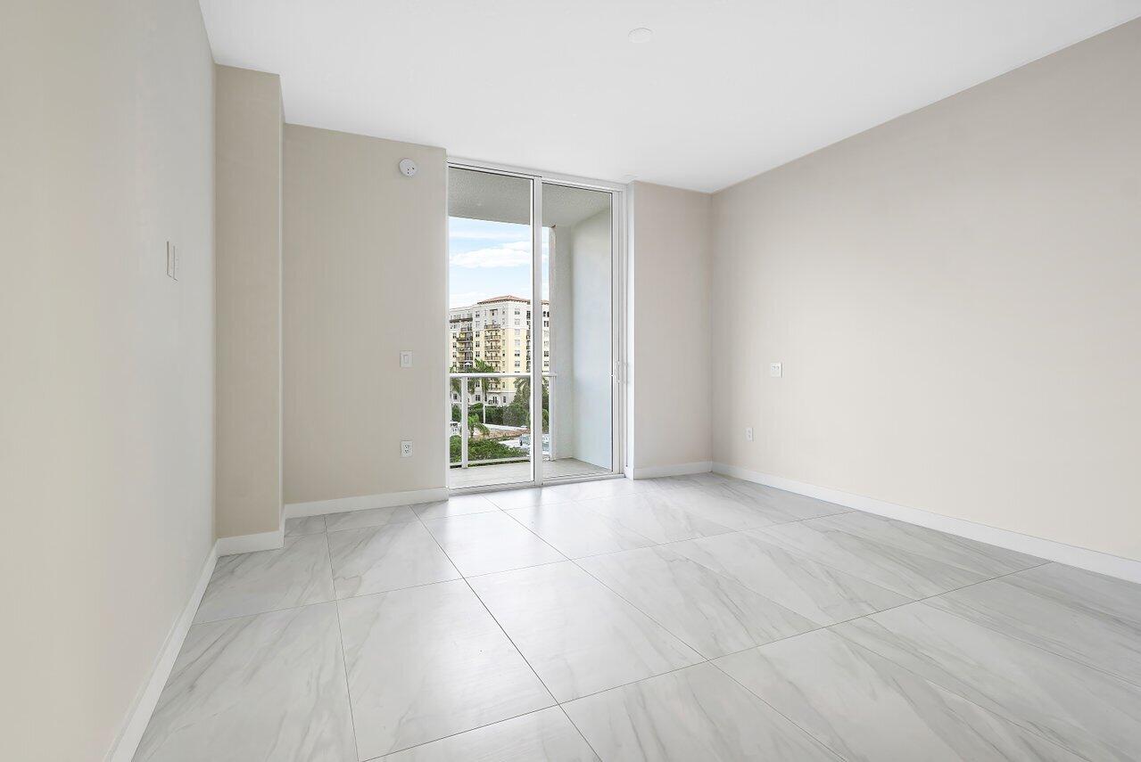 220 Southeast Mizner Boulevard, Unit 506 Boca Raton, FL 33432 - Photo 23 of 64 an empty room with windows