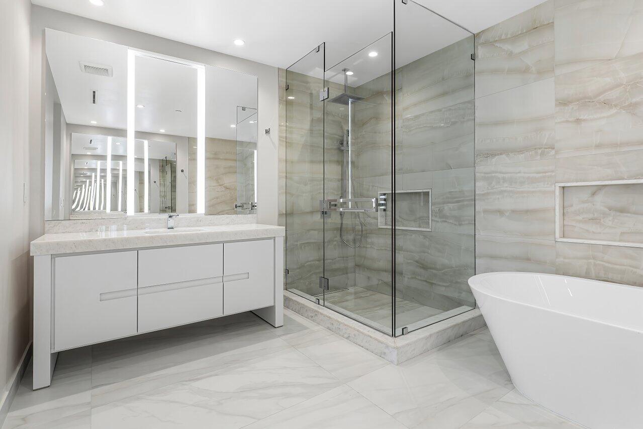 220 Southeast Mizner Boulevard, Unit 506 Boca Raton, FL 33432 - Photo 26 of 64 a bathroom with a tub sink mirror and shower