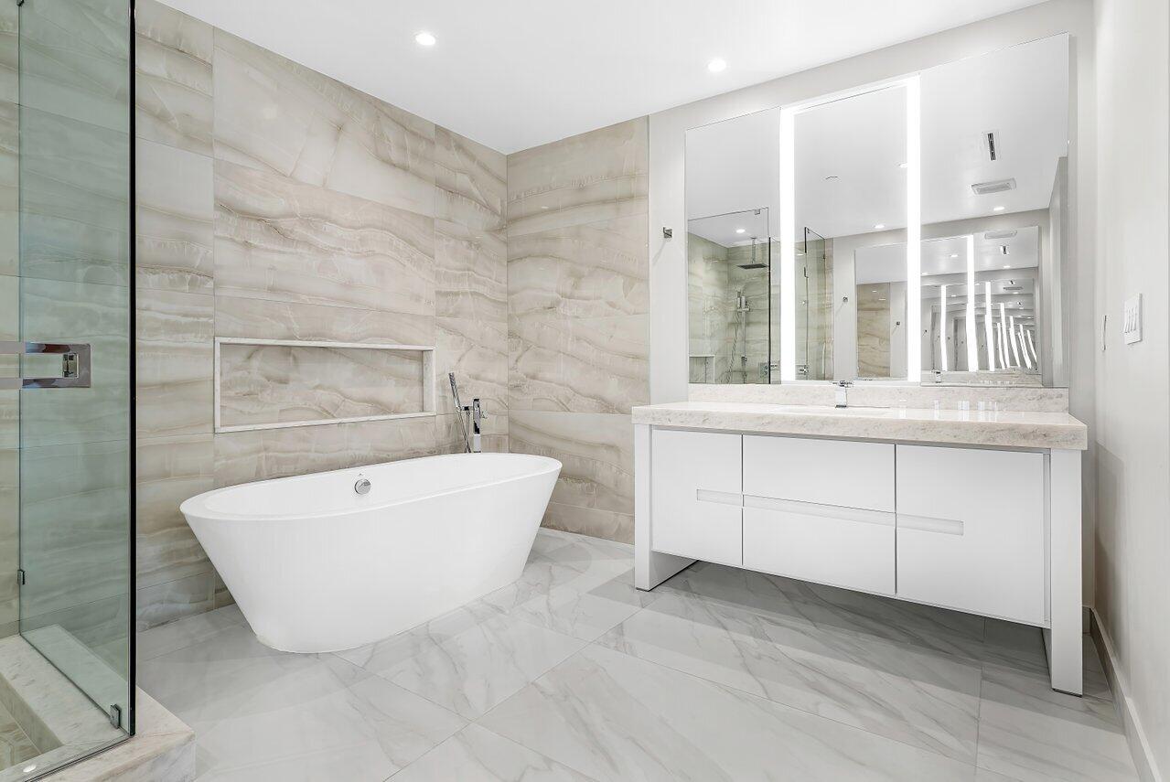 220 Southeast Mizner Boulevard, Unit 506 Boca Raton, FL 33432 - Photo 27 of 64 a bathroom with a bathtub and a shower